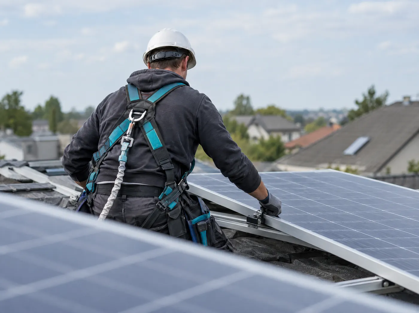 Solarteur montiert Photovoltaikmodule auf einem Dach, Symbolbild zum Ratgeber „Fördermittel vom Bund: der Überblick für Gründer“